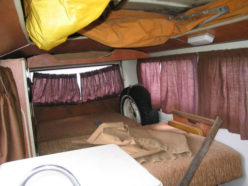 The interior isn't that bad.  Has a sink.  Z-bed works.  Has both cots!  Now if we could only find the keys...
