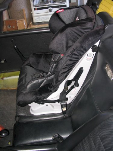 Car seat anchored in with the shoulder belt and a seat belt locking clip.
