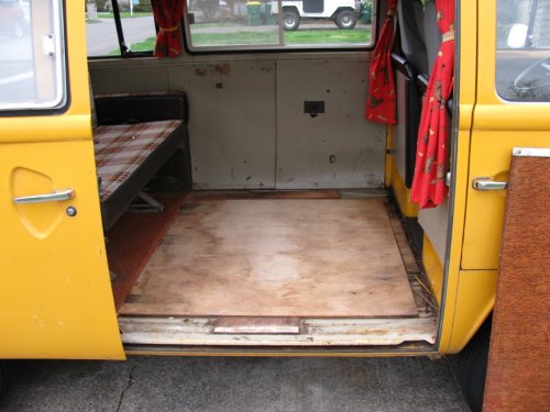 Sheet of plywood with carpet glued to it removed.   Exposed are additional plywood pieces that everything is screwed into.  Note that these pieces of plywood are screwed to the Bus floor.  I really don't think it's necessary but luckily only a couple screws were used.
