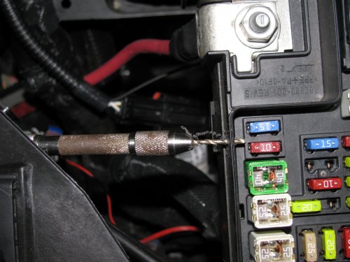 Connecting the DRL LED array.
I used a hand drill with a 2mm drill bit (smallest I had) to carefully drill a pilot hole into the side of the relay box.  The pilot hole is 7mm down from the top of the lip of the fuse/relay box.  It's between fuses M20 and M27.
