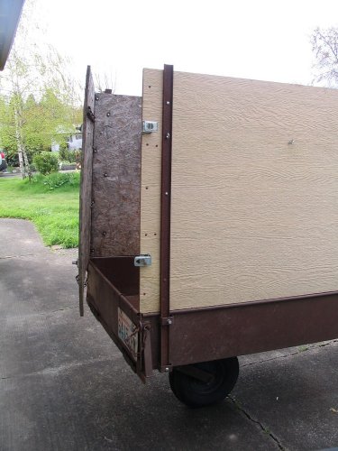 The top wooden box comes off the lower metal box.  The wooden box has a door and the lower box has a drop-down tailgate.
