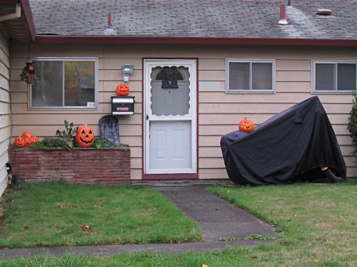 Front decorations.  A little sparse this year.  The pumpkin on my motorcycle is a real one I carved.  I cut out a ghost in the back so when lit it would cast the image of the ghost onto the house.  I didn't get a good photograph of it but the effect was good.
