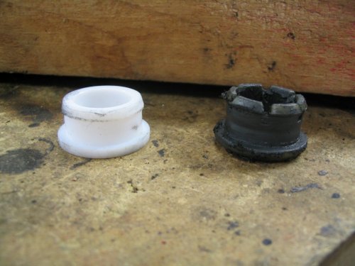 Firewall bushing for shift rod.  The white one on the left is the new unit and the black one on the right is the original.
