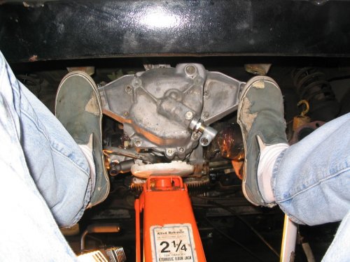 New tranny going in the opposite way it came out.  This was my view of wiggling and pushing the tranny into the car, trying to get the lower engine studs to pass through the tranny bell-housing holes as well as having the splines line up on the tranny input shaft.
