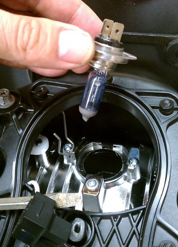 Remove the puny OEM bulb.  Carefully put it aside and don't touch the glass.  You may want to save it as a spare, just in case.
