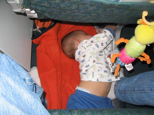 Little Boy snoozing during our flight to Denver.  This worked out rather well.
