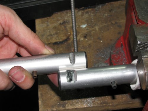 The top bar has the stock groove in it and the bottom one shows the extra material I had to remove, about 3/4 of the width of the original groove.  Both bars required this modification.  This allows the bar to be positioned "down" more so the reservoir clamps/brackets can fit on the bars.  I used a hack saw to make the initial removal of material then used a rat-tail (round) file to further remove material and neaten the curves.  Remember to remove just a little instead of too much!  These are aluminum and it's very easy to work with.
