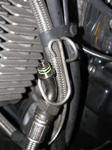 Attach the Hypermotard line loosely to the engine.  Remove the breather bracket from the  front left side of the engine (5mm Allen wrench) and then remove the breather line from the bracket.  Position the bracket on the existing oil line and insert the new line as shown.
