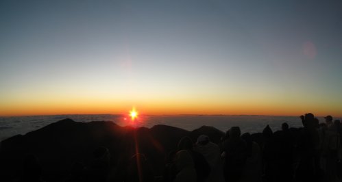 A very small sliver of people watching the sun rise.

