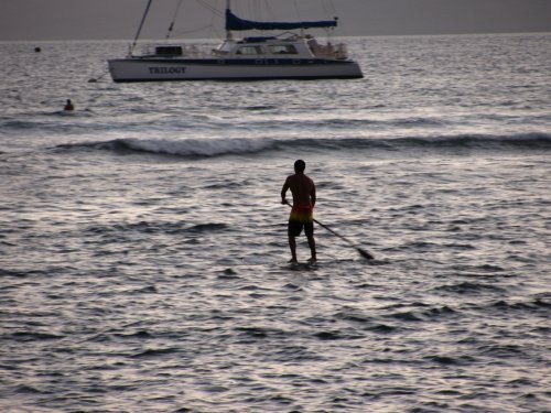 Looked like a local paddling his board out into the surf.

