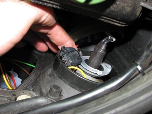 Whatever plug you may have, simply push the connectors into the gap on the inward side of the light housing as this has a good gap to hold it out of the way.
