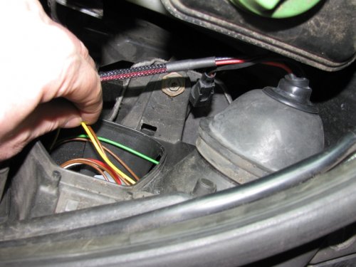 Gently pull on the brown and yellow wires to help keep the connector in its place when putting the rubber boot back on.
