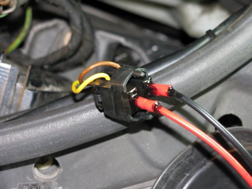 The bulb I originally had for the left side was bad so I got a replacement.  This had the wires through it but no connector.  Overall, it is better as there was no need for me to cut the wires, push them through the gasket, and butt-crimp them.  For the connection, I pushed the spade connectors into the stock connector, dabbed liquid electrical "tape" around it to electrically insulate it as well as help hold the connectors, then wrapped the connector in electrical tape to further hold the connectors in.  Not ideal at all but it works.
