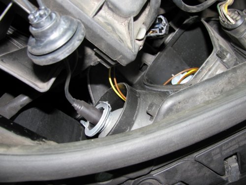 Right side
This is the side I started on and passed the harness through the hard cover as recommended by a shop that does the procedure.  What a MAJOR pain in the butt!  Ideally, it would be best to REMOVE the airbox in order to get enough space to maneuver around; a much bigger task than I cared to do after 3 hours of work involved already!  I have long thin fingers and trying to get the bulb in the socket, as well as the gasket into the hard cover, was quite difficult.  Anyone with thicker and/or shorter fingers would likely have an even more difficult time as the space is just too cramped around that area.
