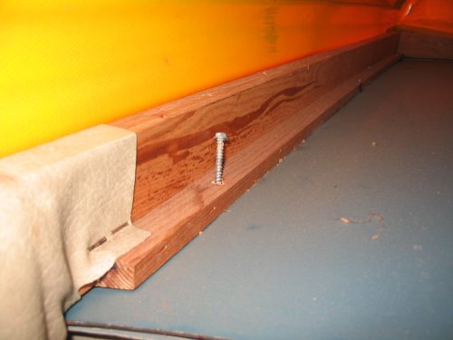 Simple sheet metal screws holding the frame to the roof.
