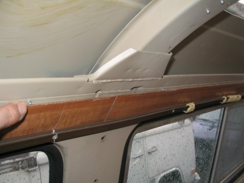 Location of left side headliner aluminum holders.  Pointing to rivet.
