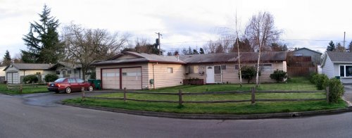 Panoramic view of property front.  Shed will be in backyard on right side of image.
