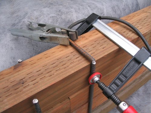 Clamp pins close together, place top of "staple" into position, and weld the pieces together.
