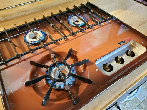 Fully-functional 3-burner propane stove top.  Knobs are missing.
