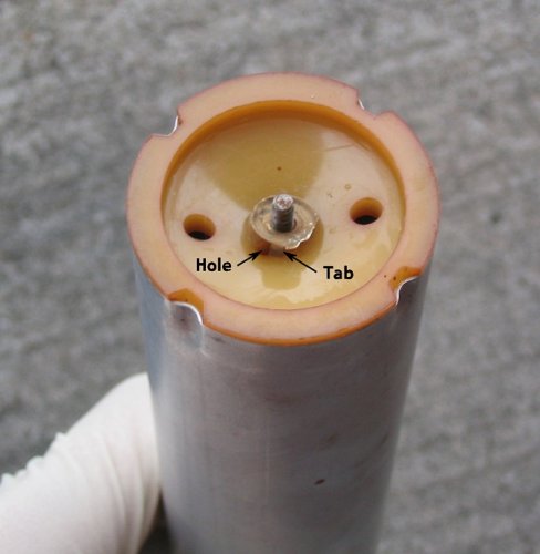 The tab fits into the hole at the bottom of the assembly tube.
